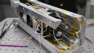 Quantum computer hardware is shown on a laboratory table